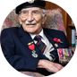 A man in military uniform sitting on a chair.